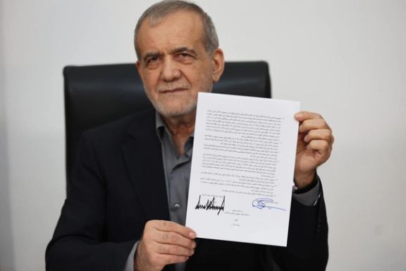 President Masoud Pezeshkian showing his copy of the MoU signed remotely with President Donald Trump. June 17, 2026