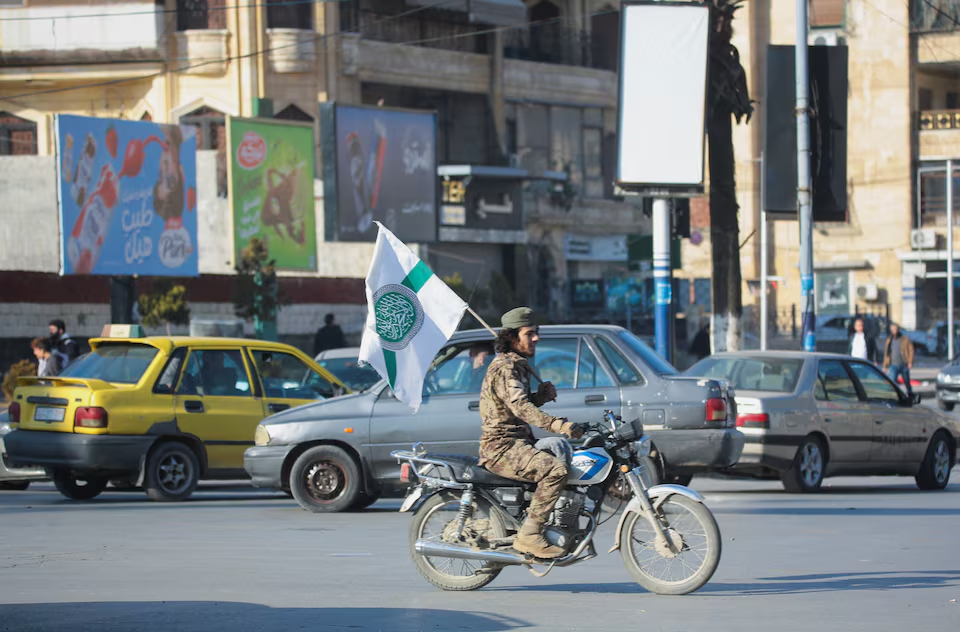 Syrian opposition fighter drives a motorbike in Aleppo, after the Syrian army said that dozens of its soldiers had been killed in a major attack by rebels who swept into the city, in Syria November 30, 2024.