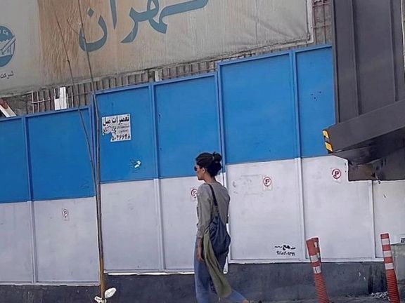 A woman walking in Tehran without a headscarf on Wednesday or Thursday